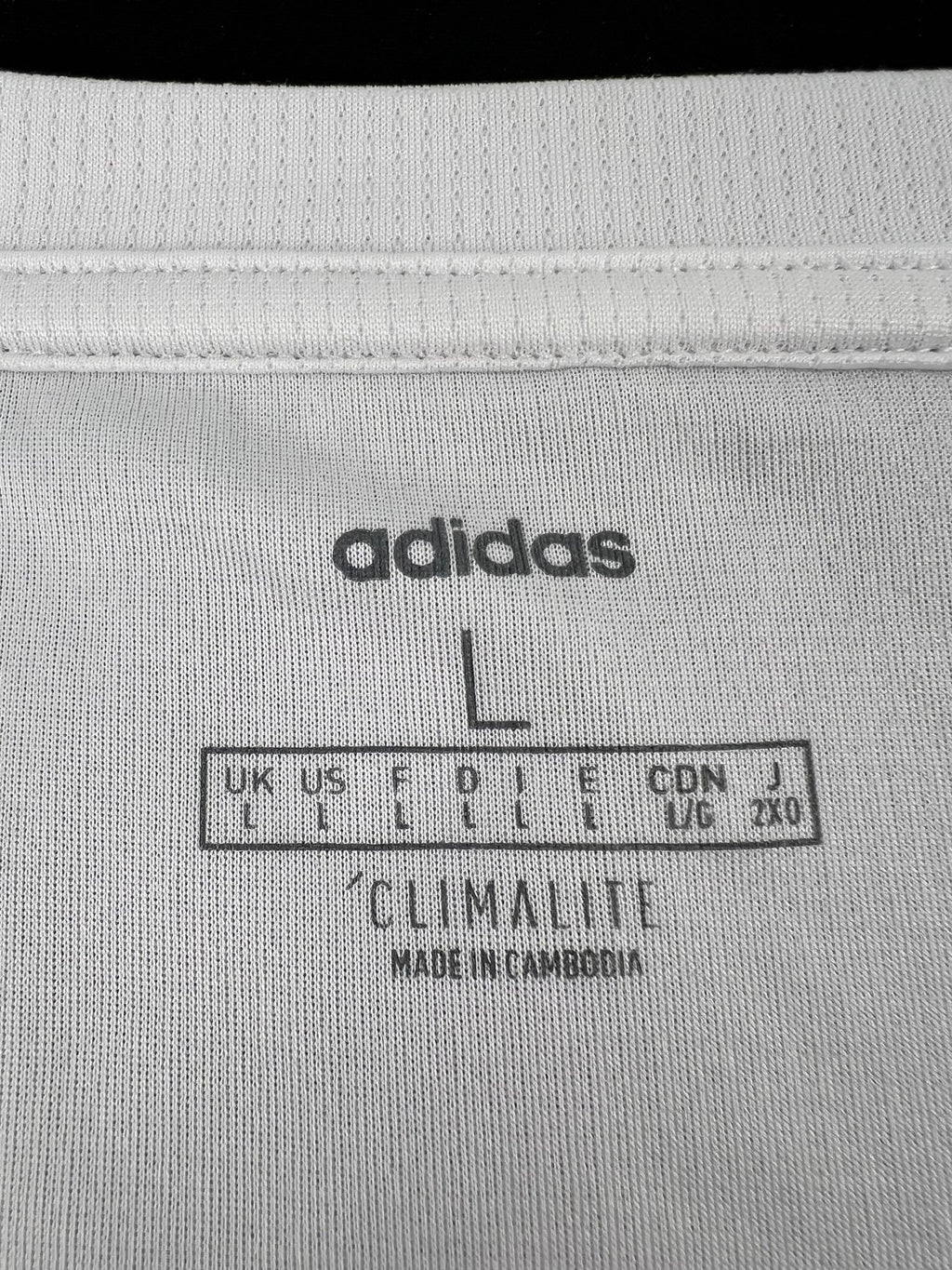 Close-up of inner label on adidas vest top showing size L and Climalite fabric