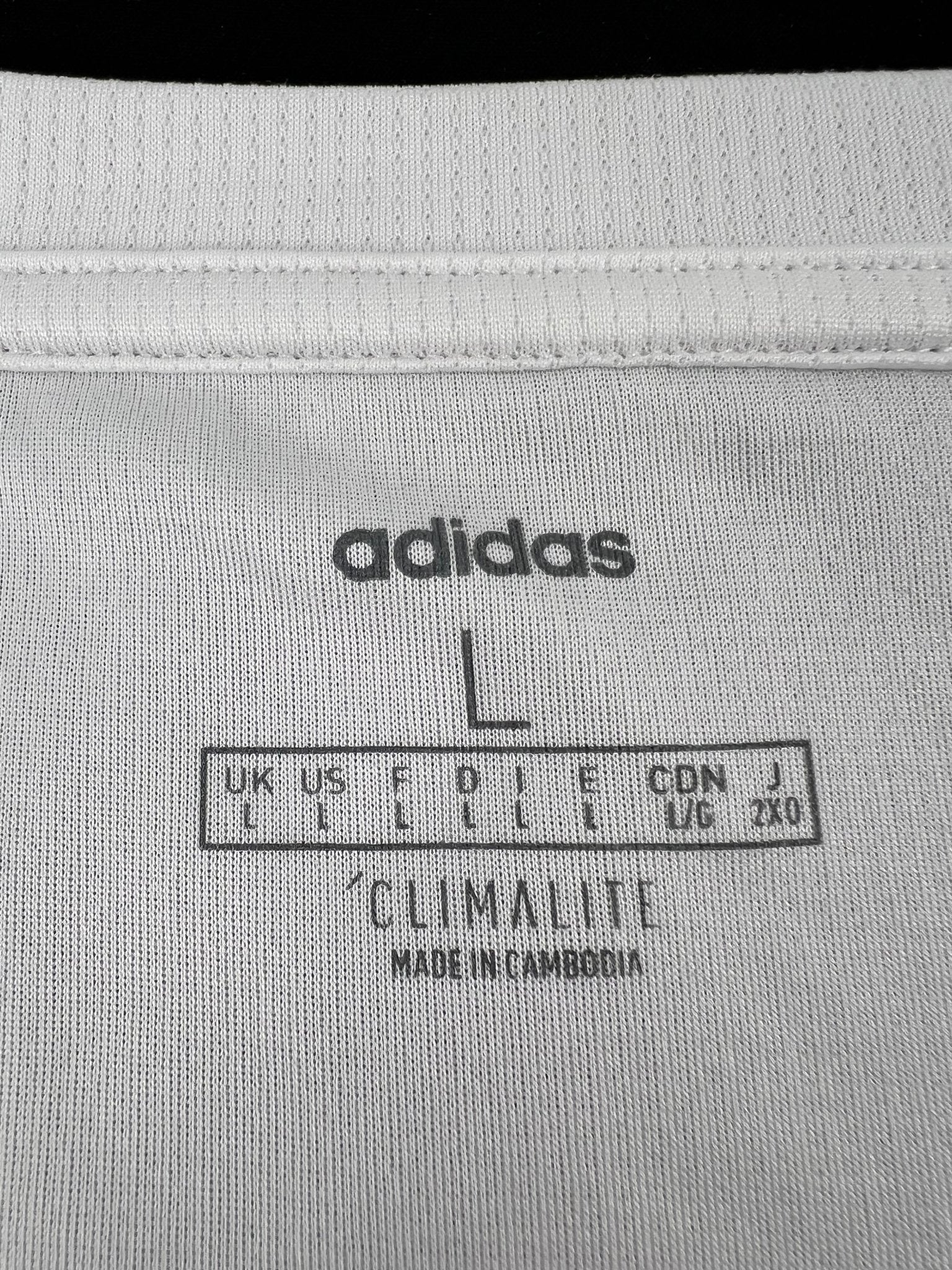 Close-up of inner label on adidas vest top showing size L and Climalite fabric