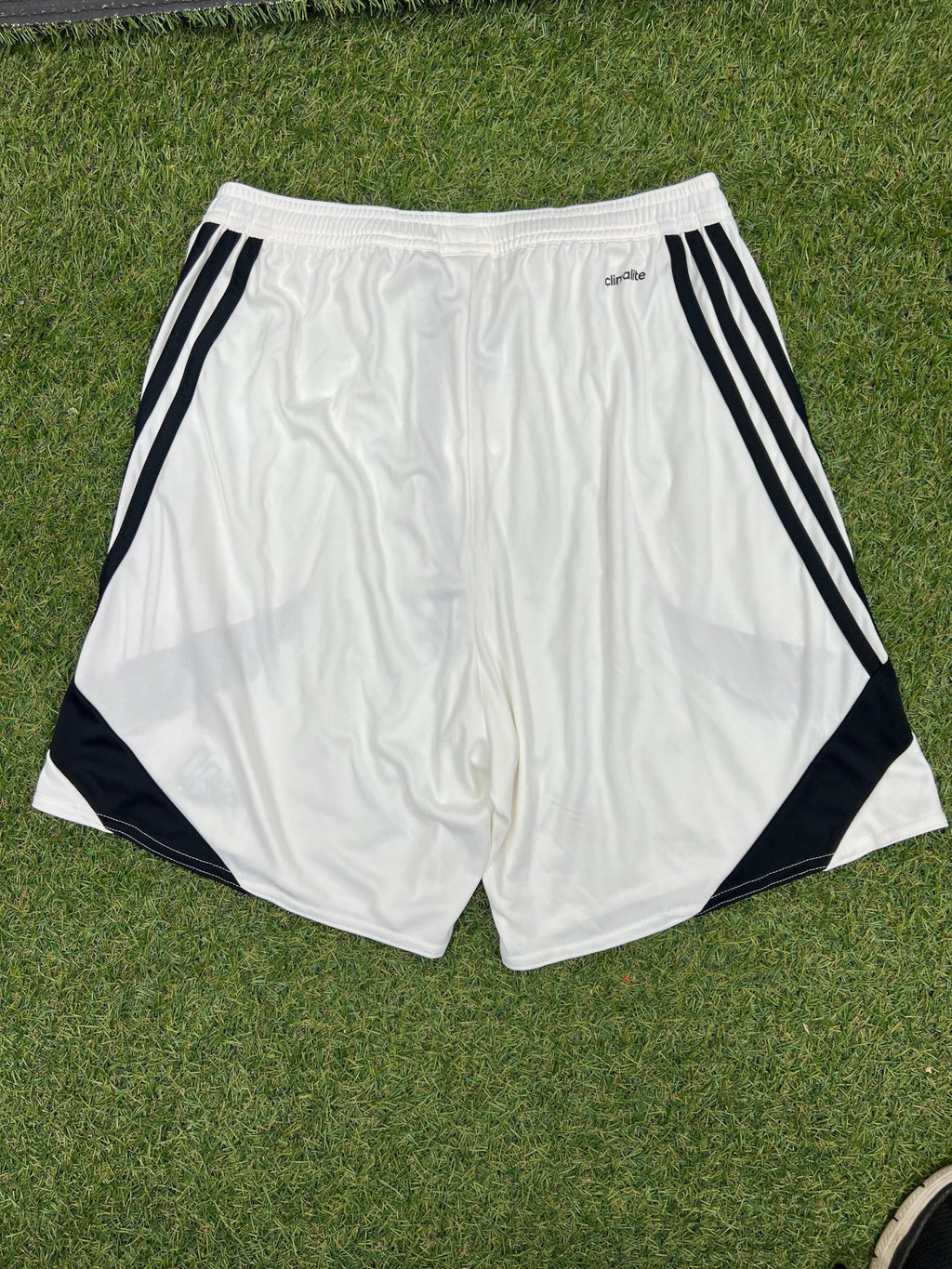 Back view of adidas white Climalite sports shorts with black side stripes
