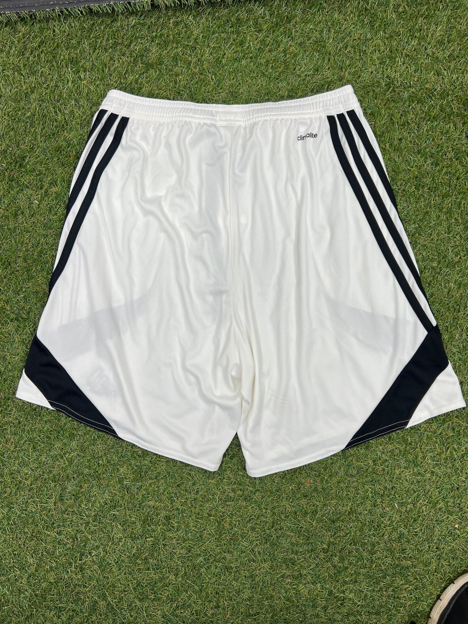 Back view of adidas white Climalite sports shorts with black side stripes