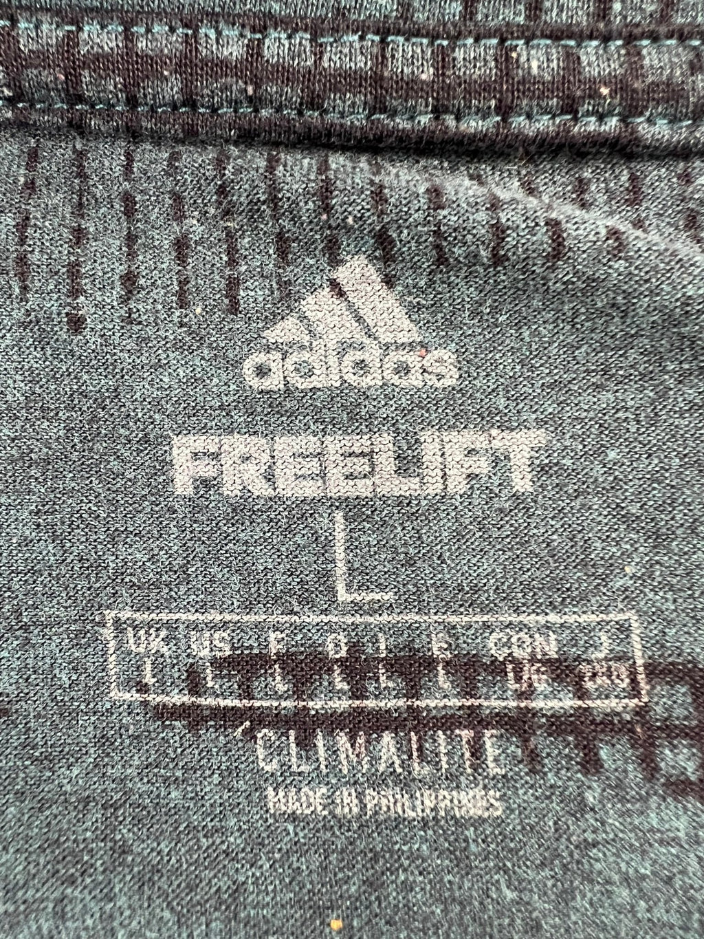 Close-up of adidas FreeLift Climalite shirt label showing size and details