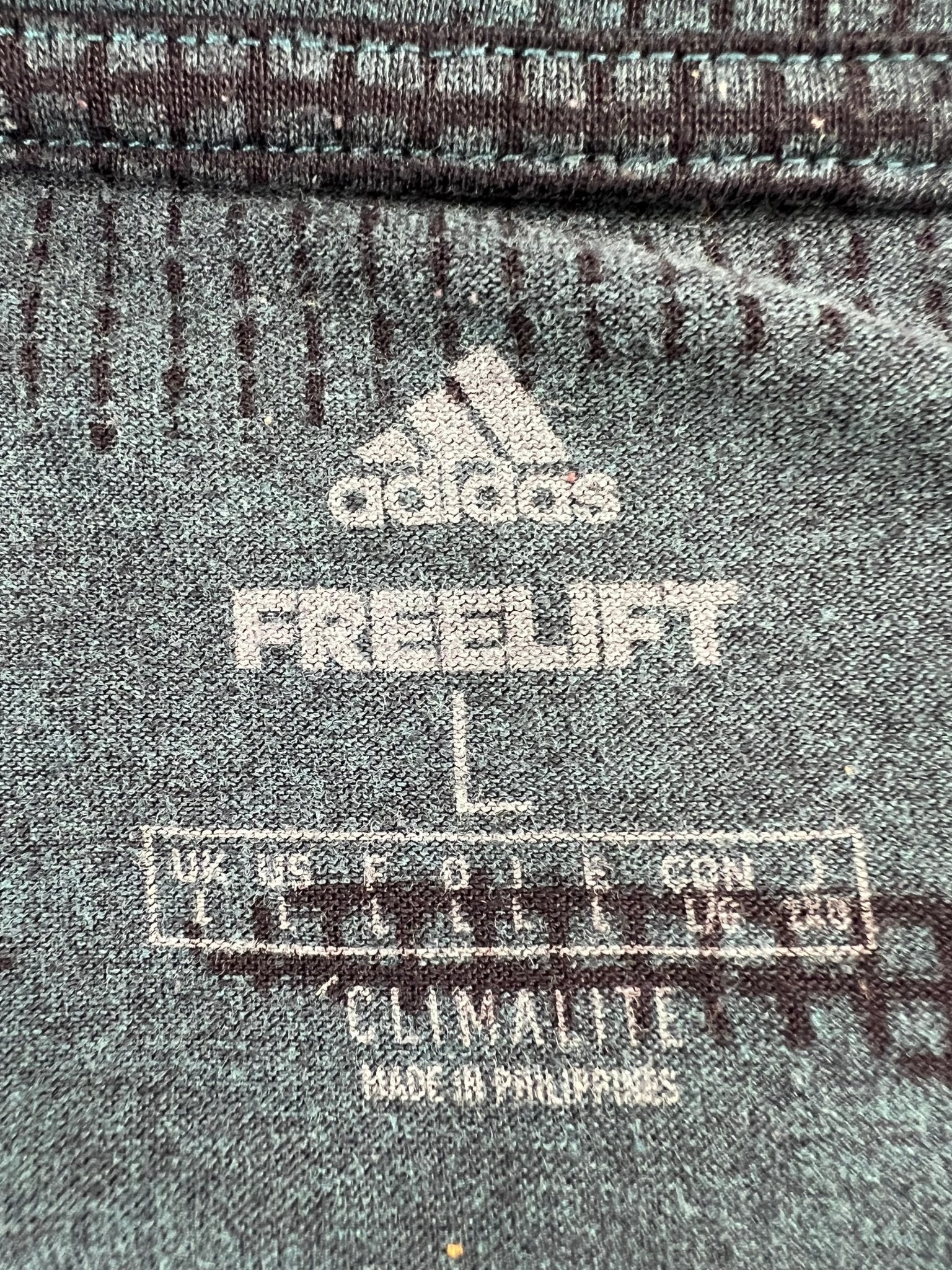 Close-up of adidas FreeLift Climalite shirt label showing size and details