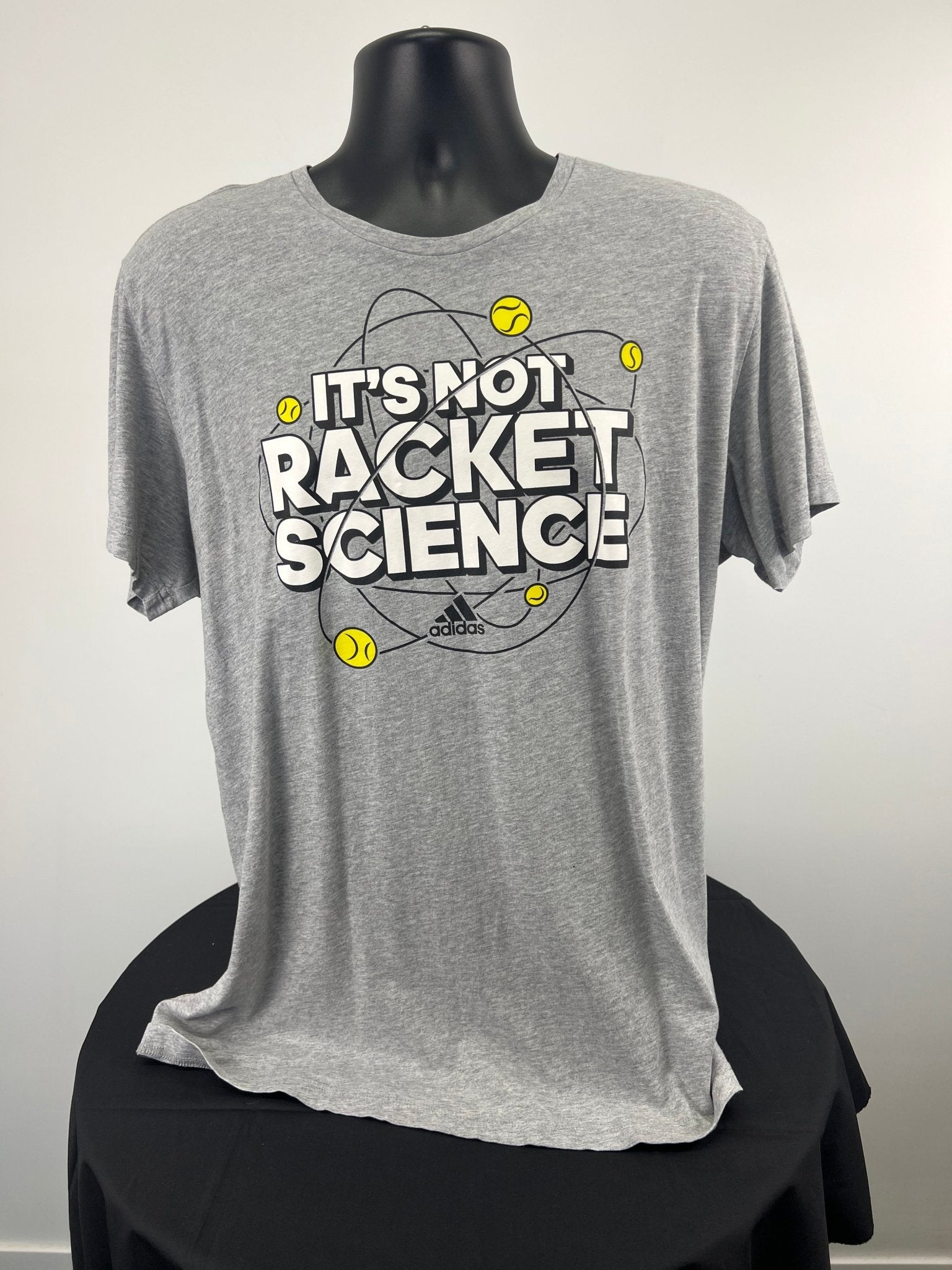 Front view of grey adidas t-shirt with 'It’s Not Racket Science' and tennis motif in size XL