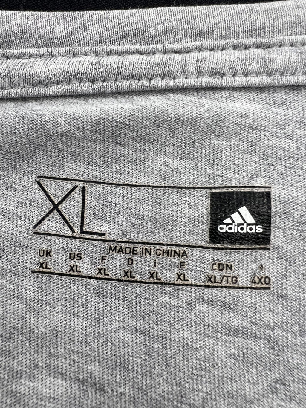 adidas clothing label showing size XL and brand logo