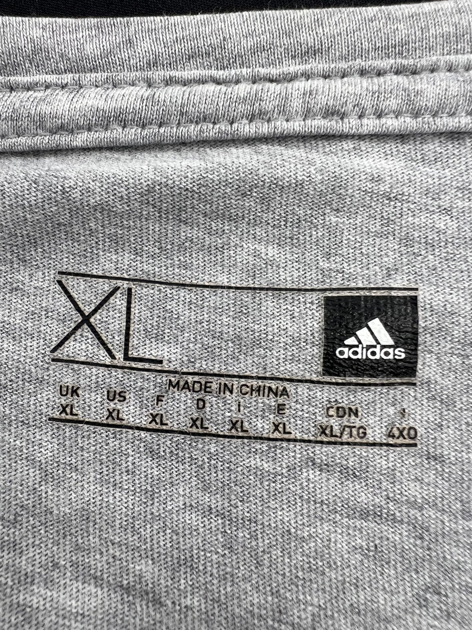 adidas clothing label showing size XL and brand logo