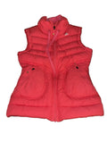Adidas pink puffer vest with high collar and zip front, displayed on grass