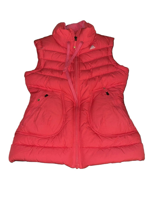 Adidas pink puffer vest with high collar and zip front, displayed on grass