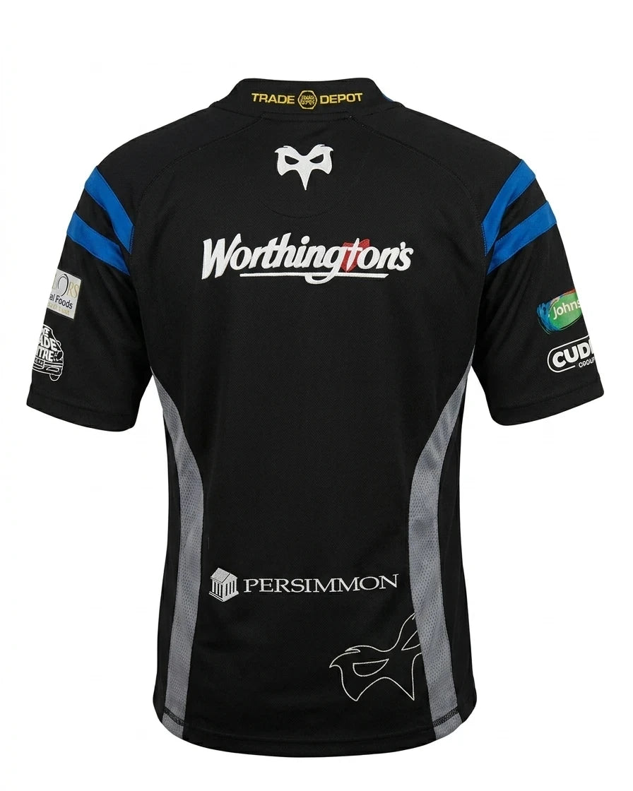 A photorealistic product shot of the black Men's Kooga Ospreys Rugby Club Short Sleeved Top, showing the rear with all sponsor logos and details, isolated on a clean white background.