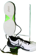 Side view of Asics men's treadmill trainer in white and black showing flat treadless sole with lime green detail