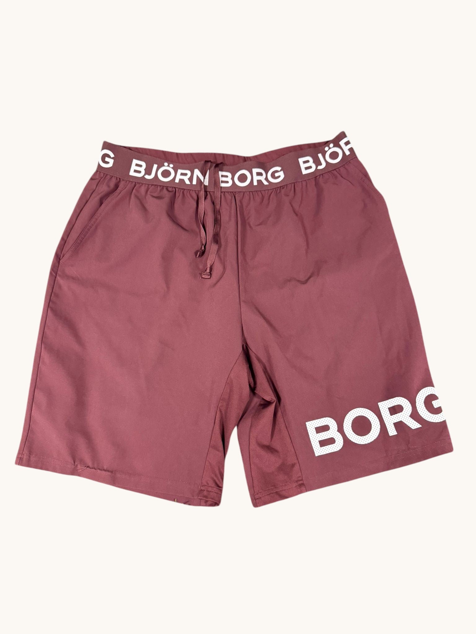 Björn Borg maroon poly-blend training shorts with elastic waistband and 'BORG' logo print on leg. Size L.