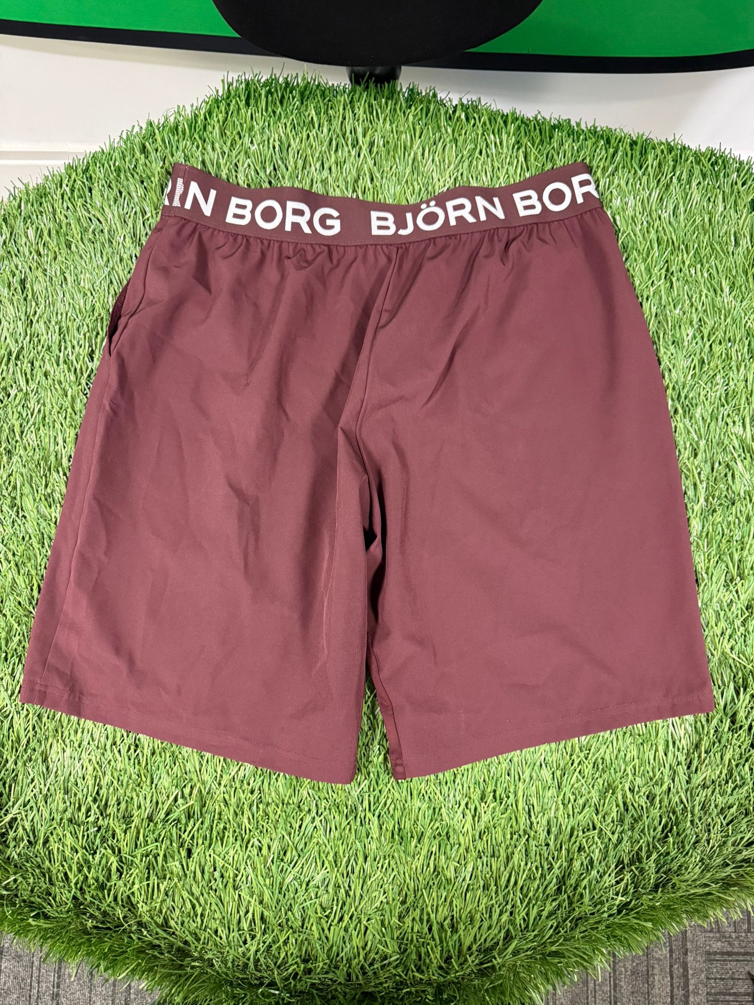 Rear view of Björn Borg maroon training shorts showing elastic waistband and plain back