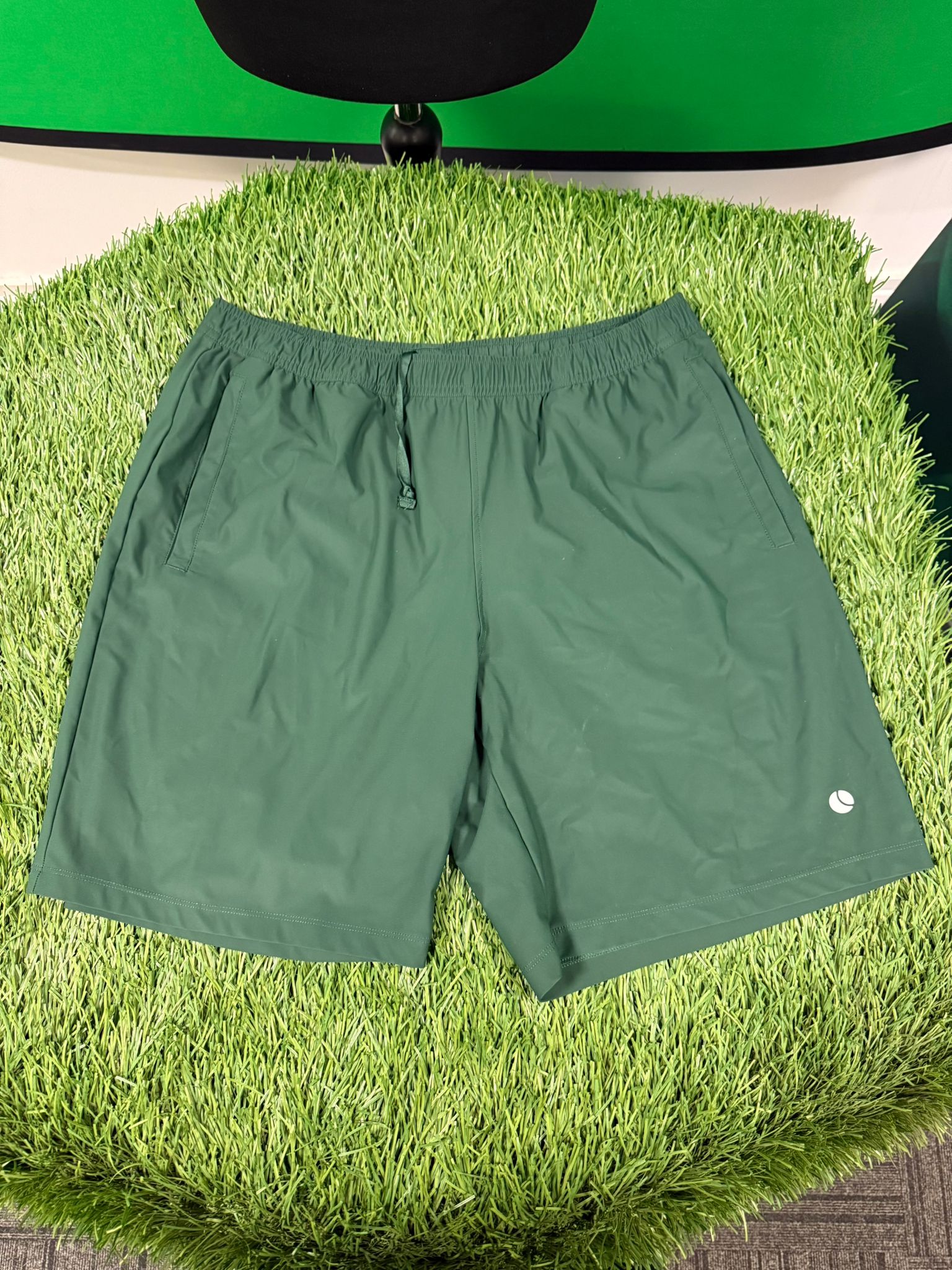 Front view of Bjorn Borg men's green tennis shorts with logo detail