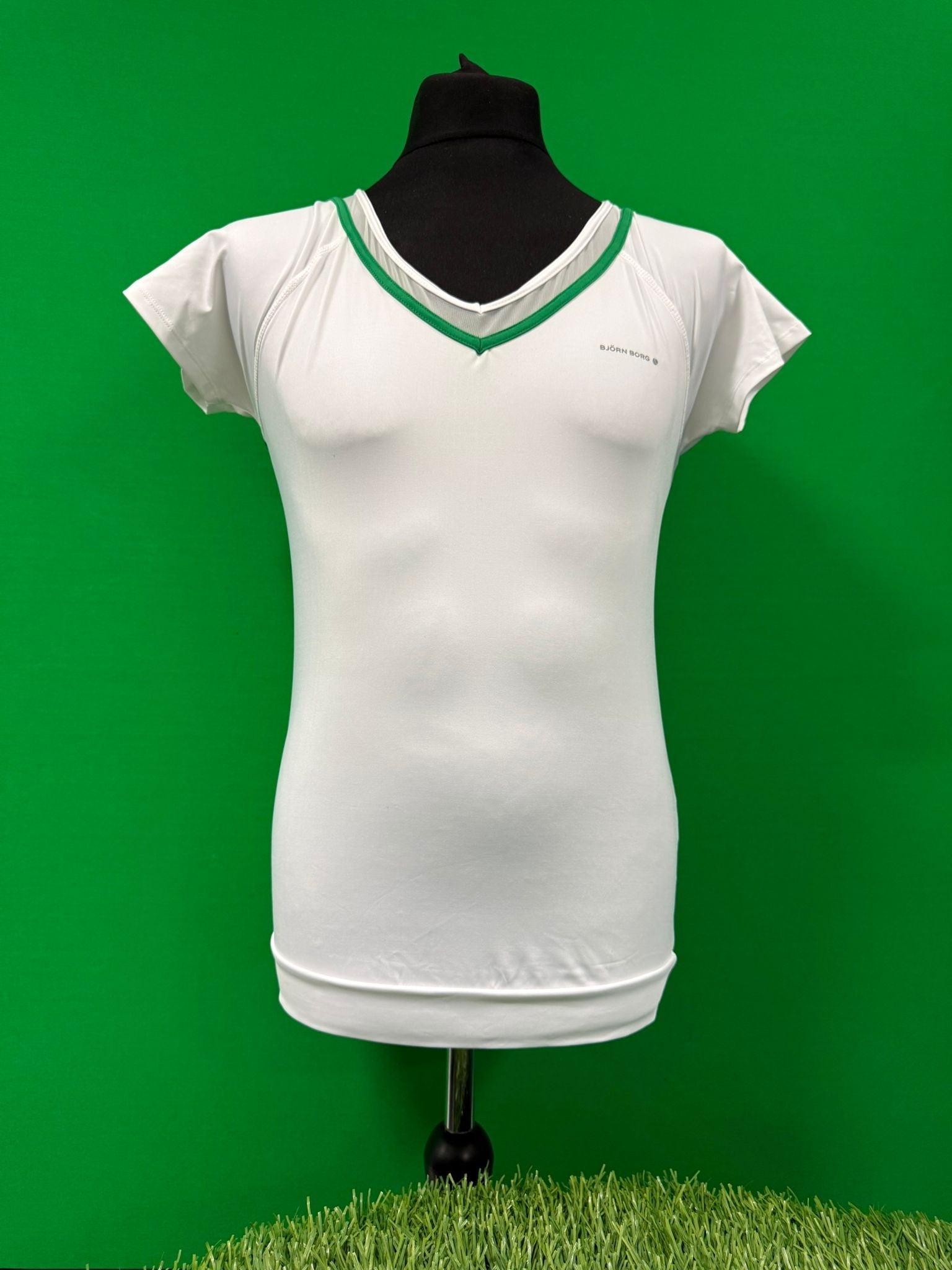 Front view of Bjorn Borg Women's White V Neck Tennis Top with green trim