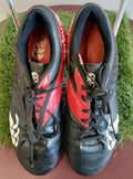 Pair of Canterbury rugby boots in black and red with visible branding