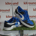 Pair of blue, black, and white DUFFS trainers on glass table