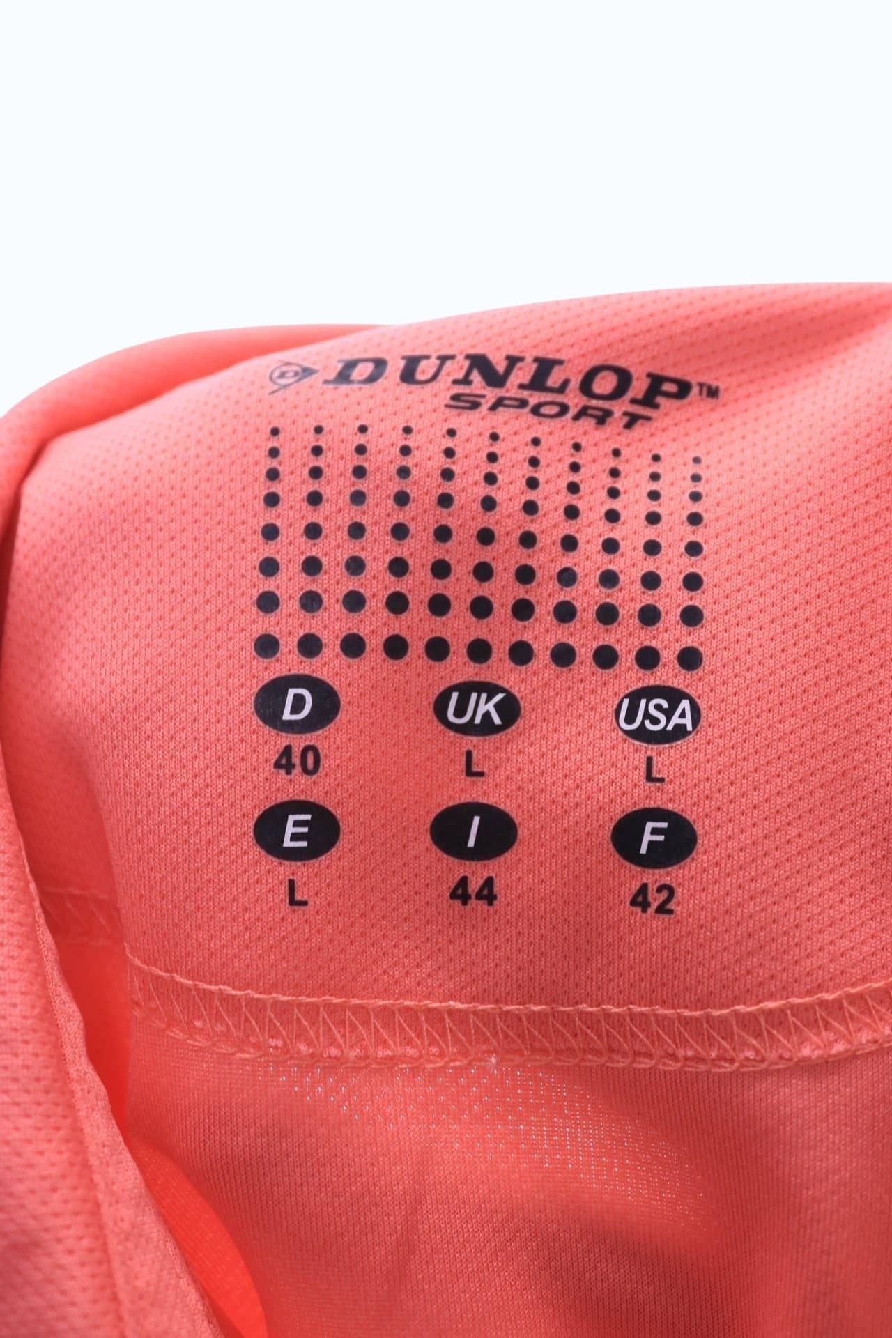 Women's Dunlop Sport polo shirt in melon orange, featuring press stud buttons and the Dunlop Sport logo. Size L.