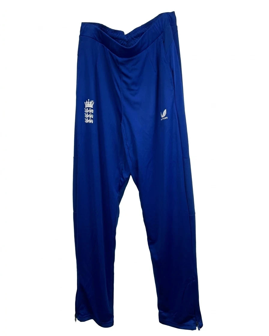 Enhanced Men’s Castore England cricket tracksuit bottoms in royal blue hanging on a hanger, front view showing logos