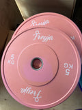 Two stacked 5kg pink bumper weight plates with Freyja branding and steel centre rings