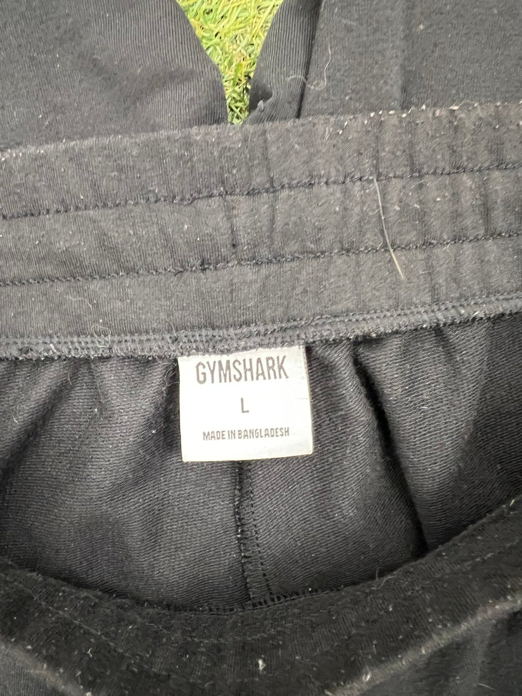 Close-up image of the Gymshark label showing size L
