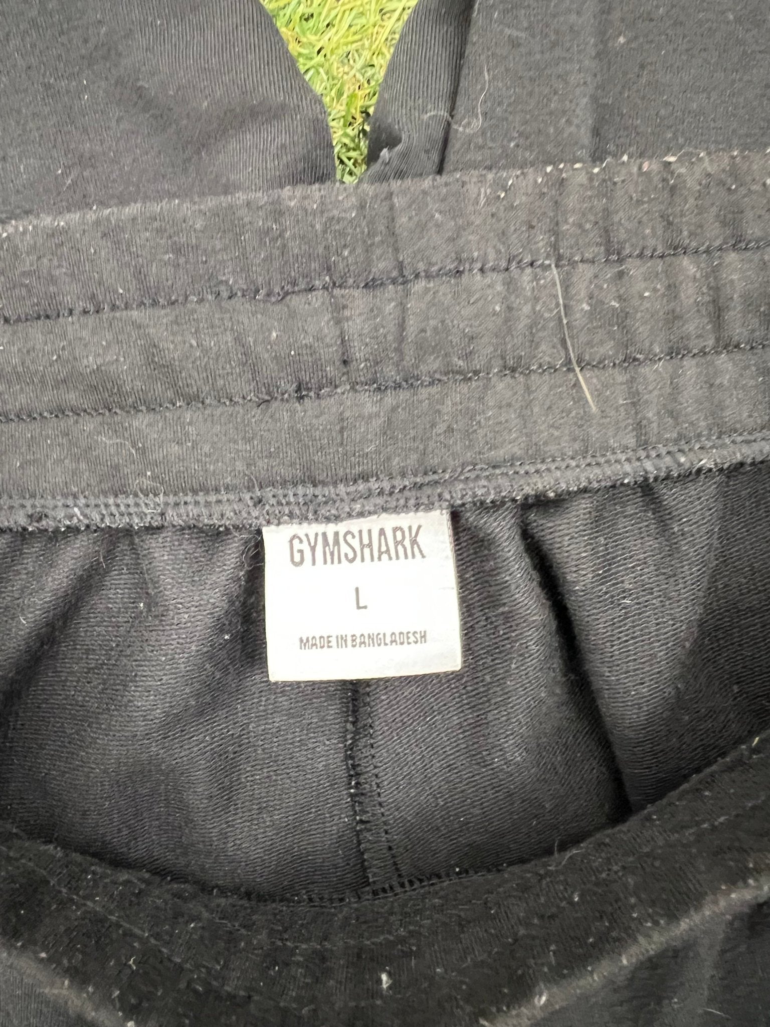 Close-up image of the Gymshark label showing size L