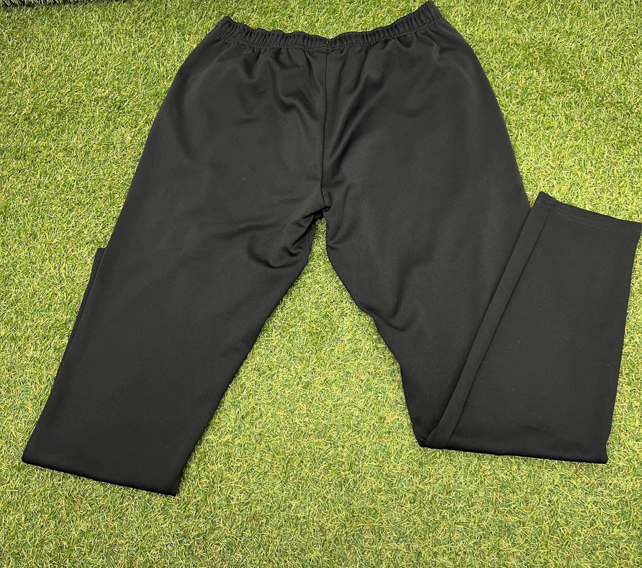 Back view of black Gymshark tracksuit bottoms on grass