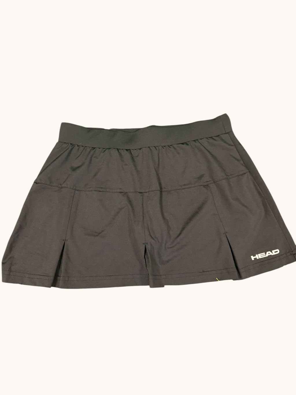 Black HEAD tennis skirt with wide waistband and subtle pleats, lightweight and stretchy fabric.