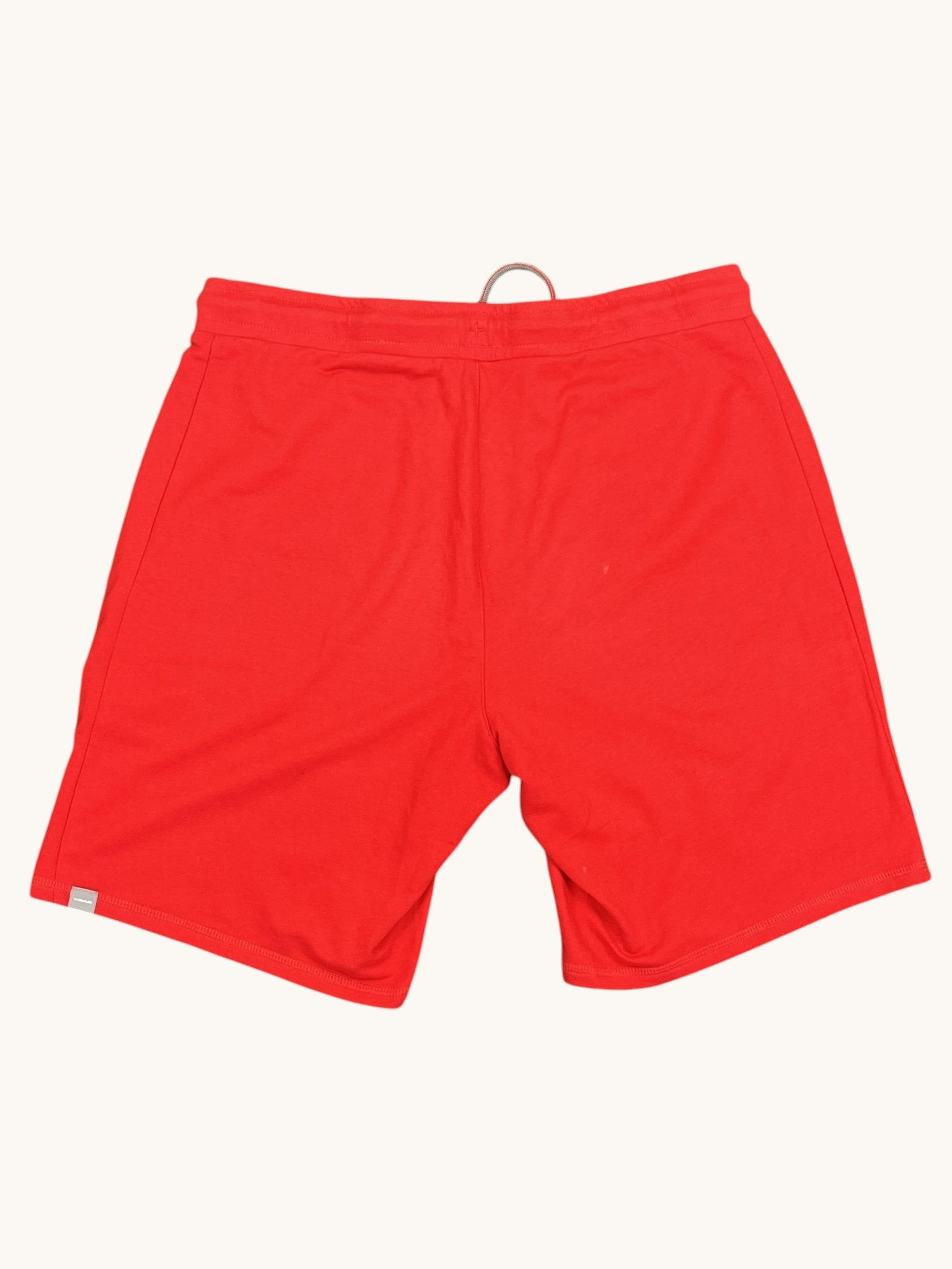 Head red sports shorts with adjustable drawstring waist and two side pockets. Made from breathable fabric.