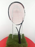 HEAD Speed JR tennis racquet with black and white frame and red strings on grass display