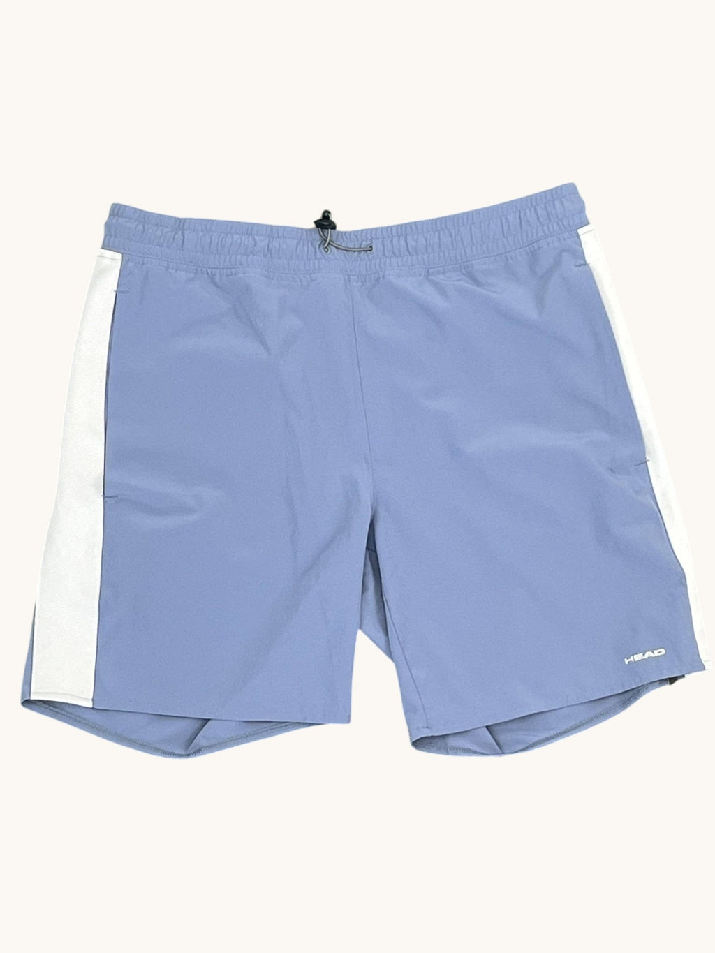 Light blue Head tennis shorts with white side stripes, elastic waistband, and drawstring. Breathable material for active wear.