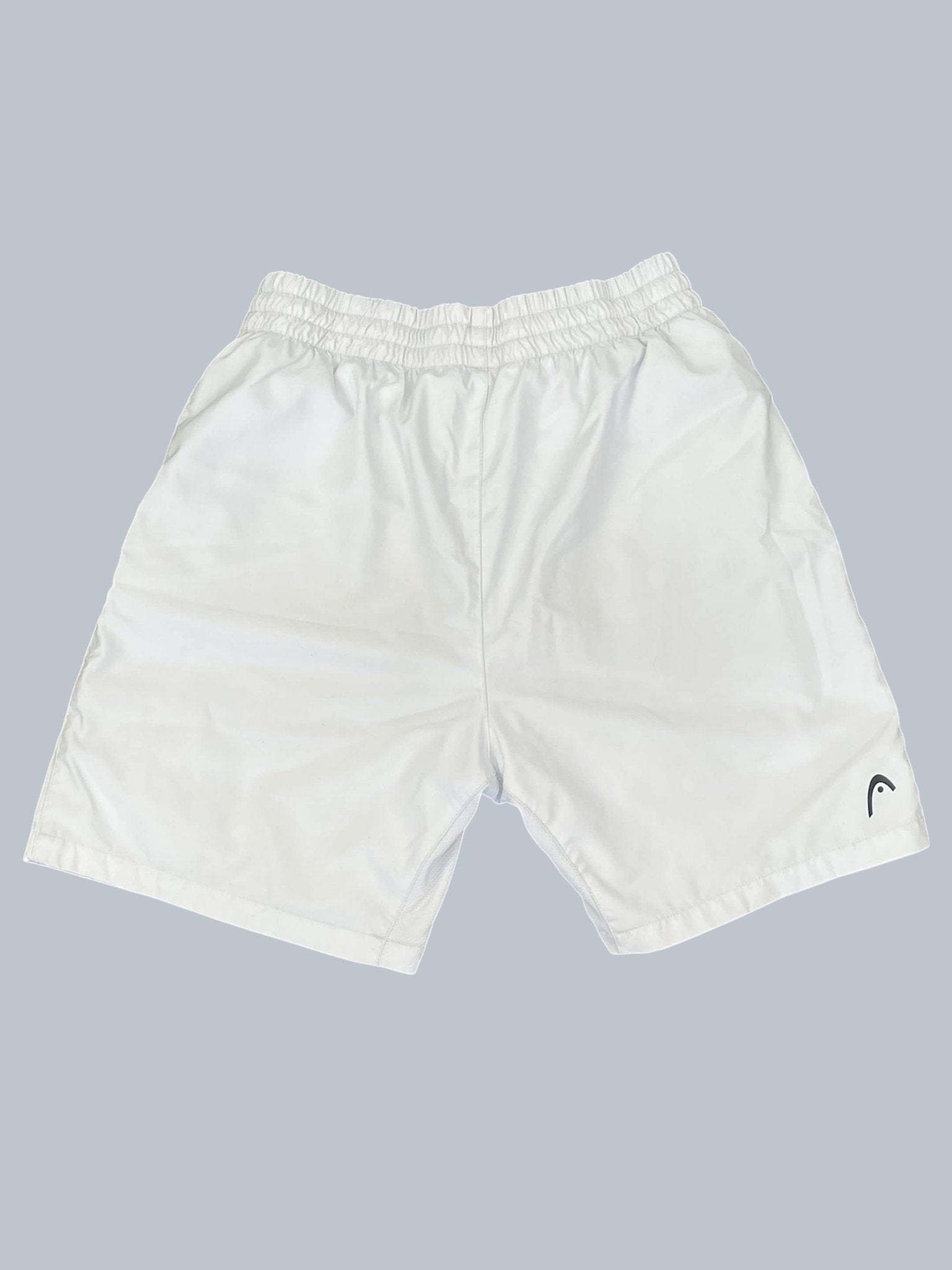 White Head tennis shorts with elastic waistband and black logo detail. Lightweight and breathable fabric.
