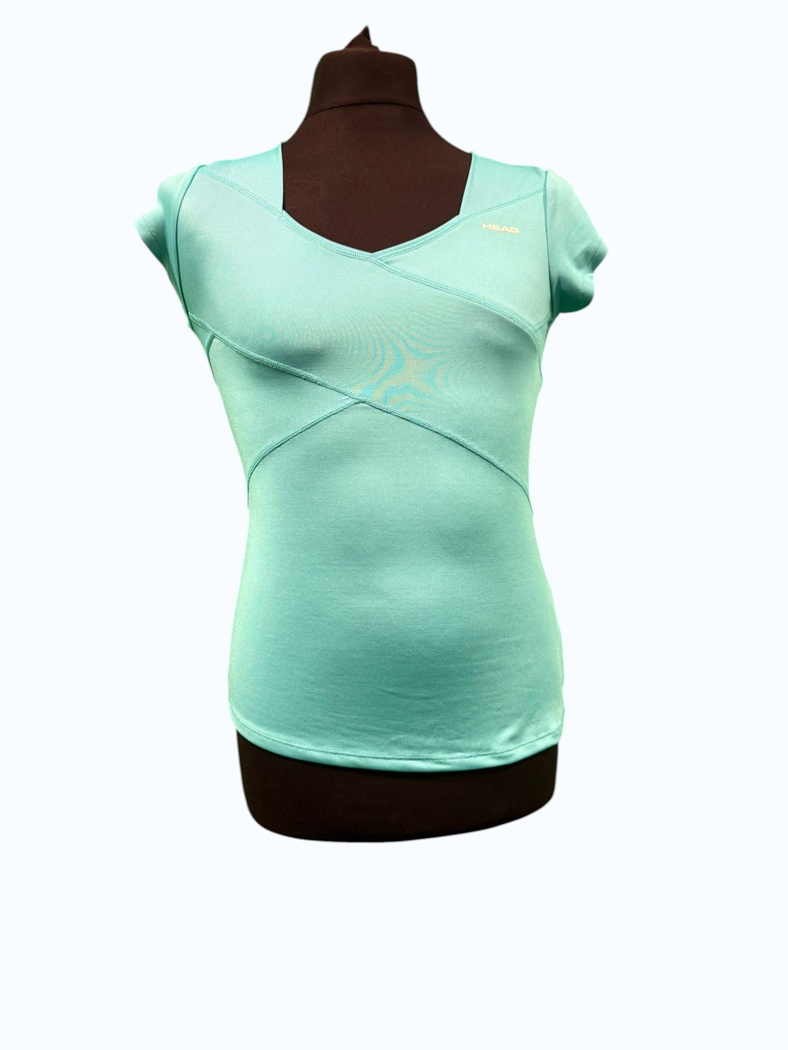 Head women's turquoise short sleeve V-neck tennis top with overlapping seam details and a fitted silhouette.