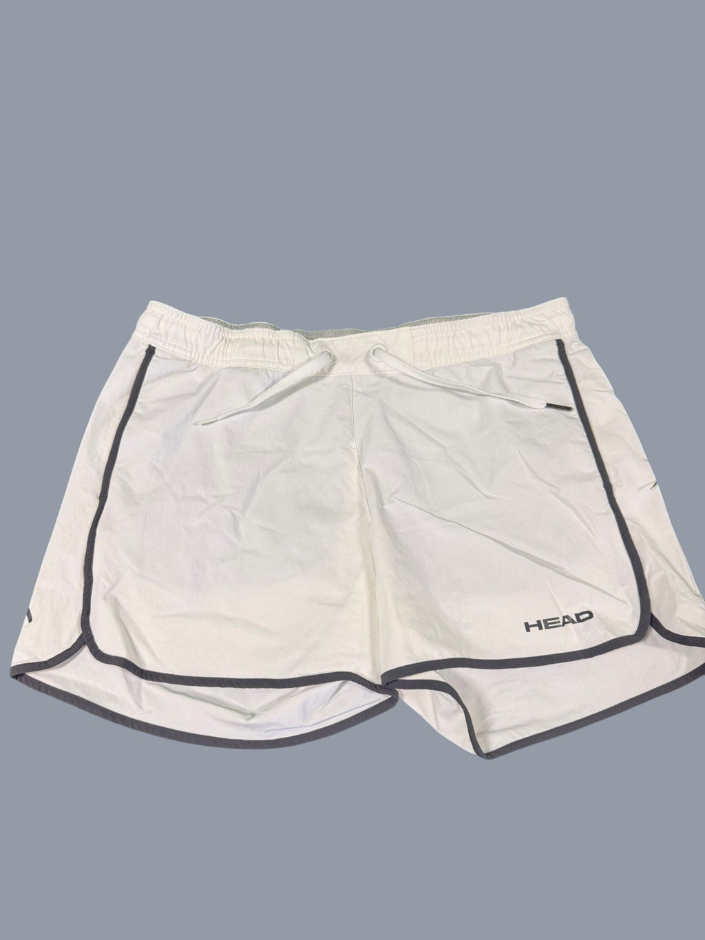 Head white tennis shorts for men with grey piping and drawstring waist. Lightweight and breathable fabric.