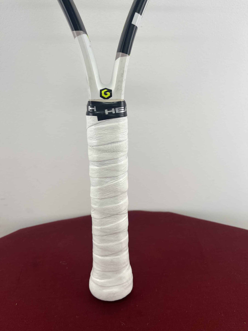 Close-up of HEAD Speed JR Tennis Racquet handle with white grip