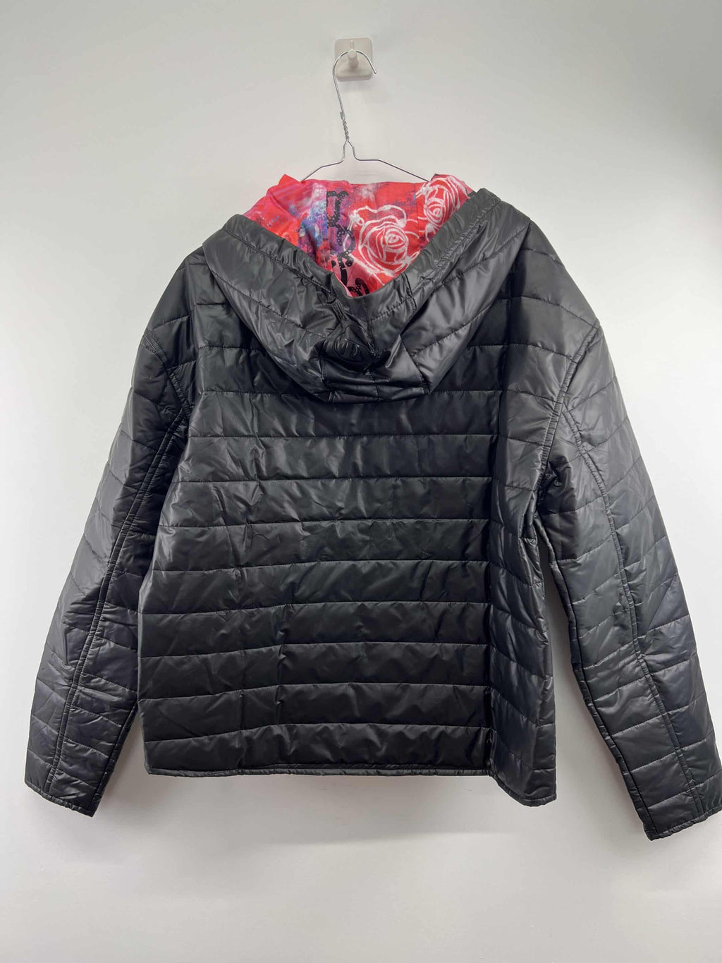 Back view of England Netball women's quilted jacket highlighting the graffiti inner lining and hood