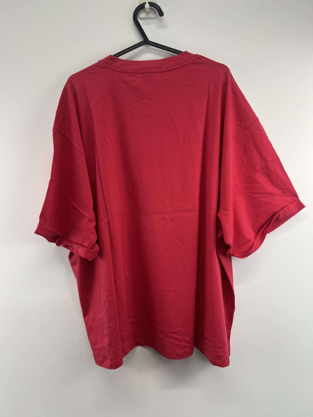 Back view of pink England Netball Roses graphic T-shirt on hanger