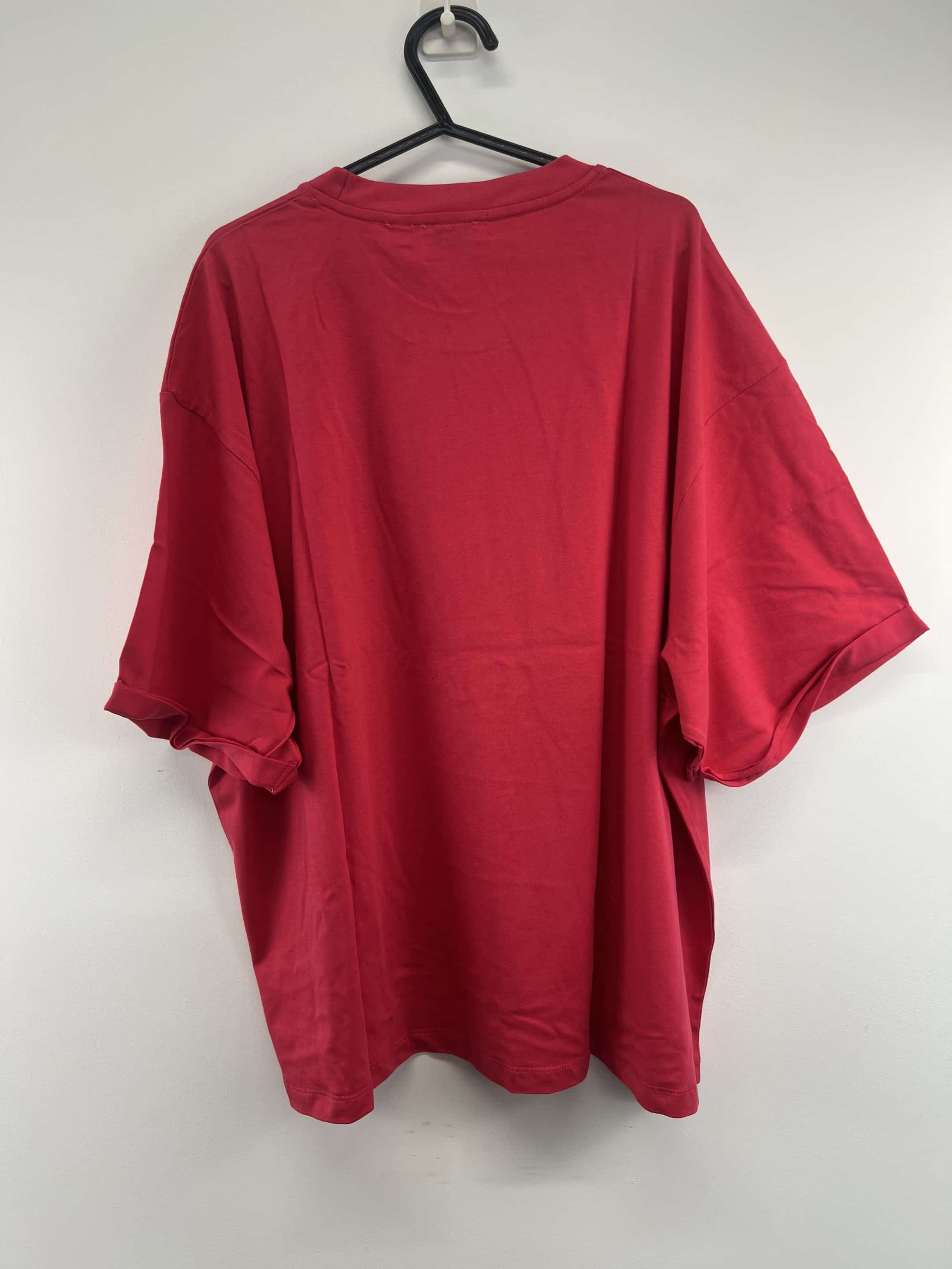 Back view of pink England Netball Roses graphic T-shirt on hanger