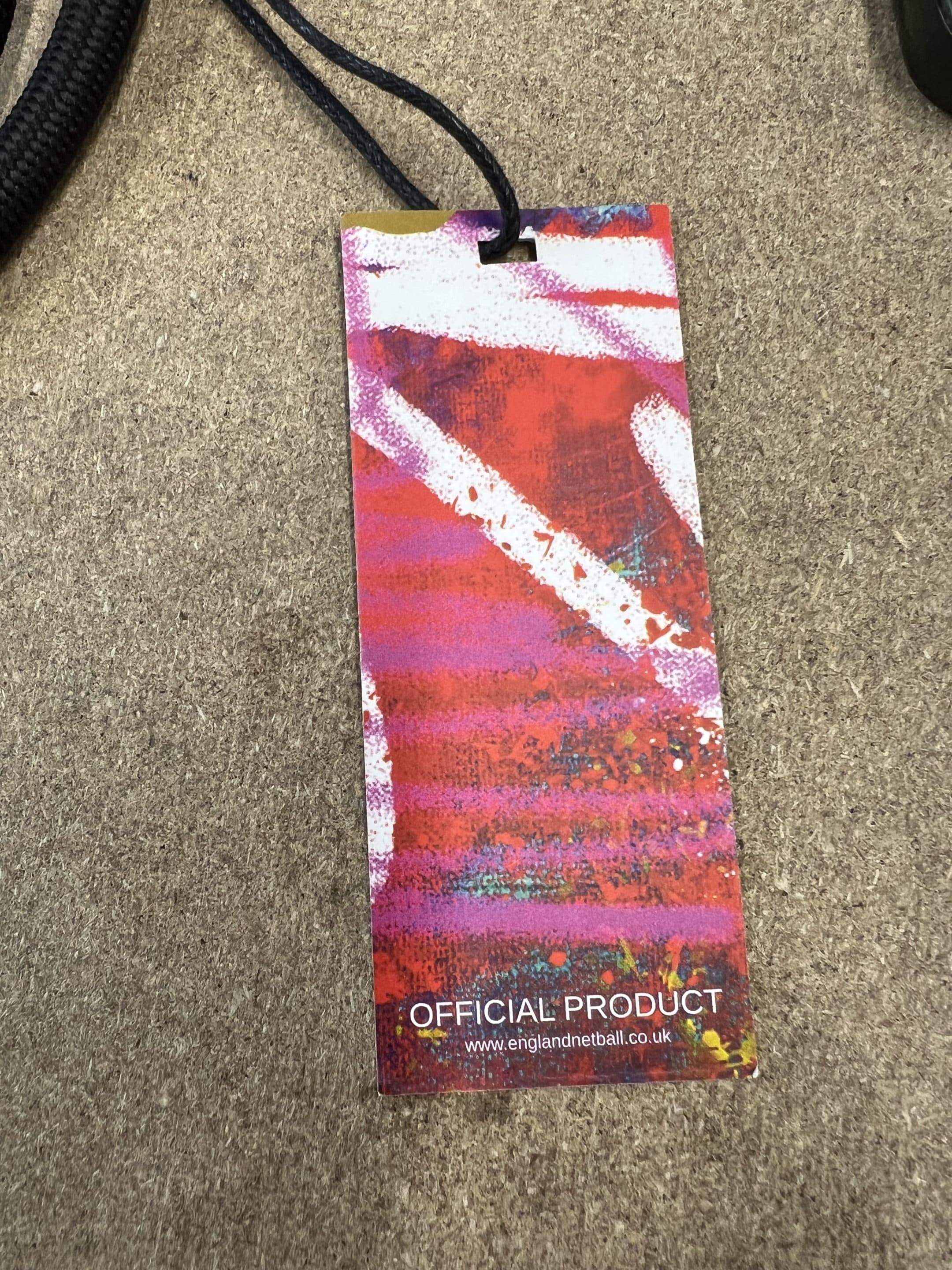 Close-up of official England Netball product tag with graffiti design