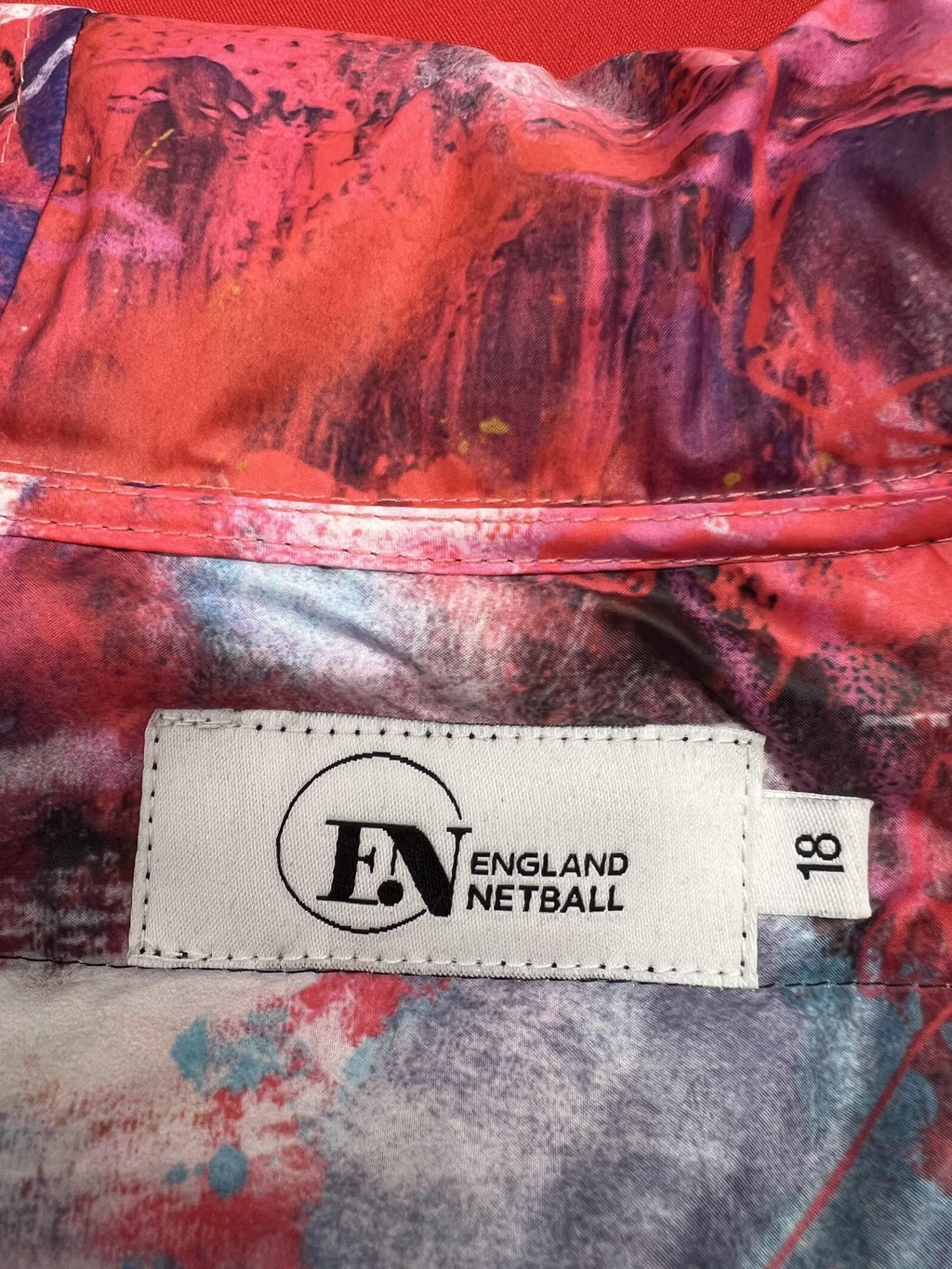 Close-up of England Netball label and colourful graffiti-print inner lining