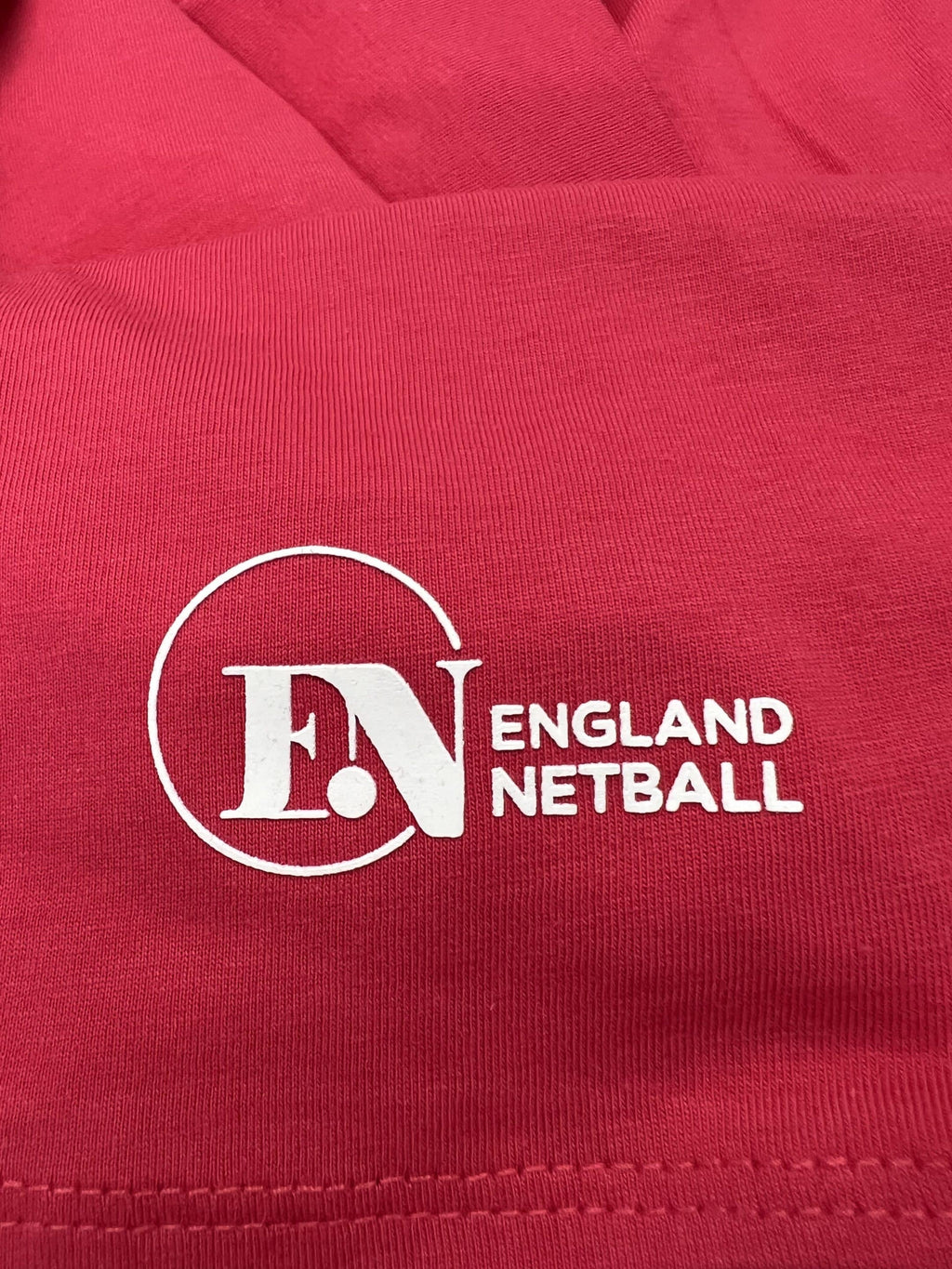 England Netball official logo printed on pink fabric close up