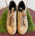 Pair of gold adidas football boots with textured upper viewed from above