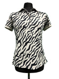 Front view of a black and white zebra print J.Lindeberg polo shirt on a mannequin, against a green background