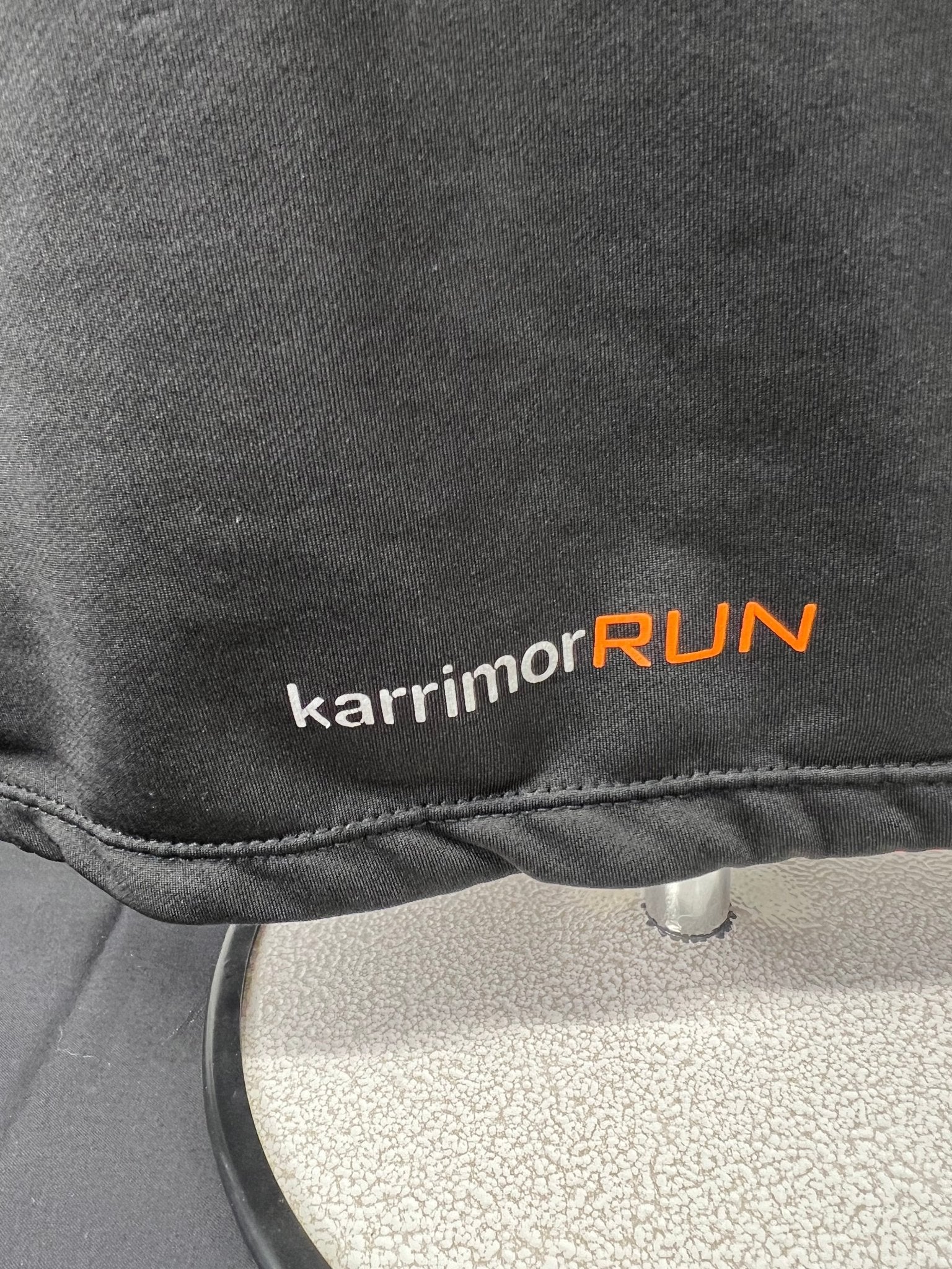 Close-up of Karrimor RUN logo on the back hem of the black top