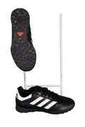 Pair of kids black adidas astro football boots with white stripes and rubber studded soles