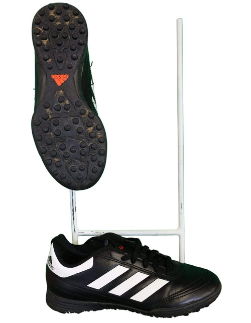 Pair of black Adidas football boots with white stripes and rubber studded soles, suitable for artificial grass.