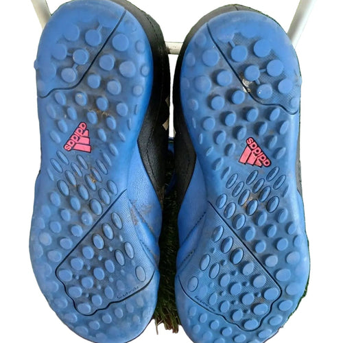 Soles of adidas kids football boots showing blue multi-stud rubber grip and adidas logo