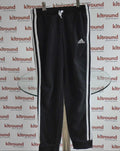 Front view of black adidas tracksuit bottoms with white stripes and brand logo