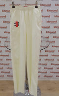 A pair of white Gray-Nicolls cricket trousers with elastic waistband and side pockets, displayed on a hanger.