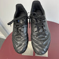Pair of black Kipsta kids football boots with laces viewed from above