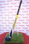 Kookaburra yellow and black hockey stick front view on grass stand
