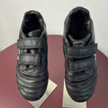 Pair of black Optimum kids football boots with Velcro straps viewed from above